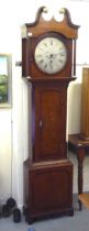 A 19thC oak longcase clock, the hood with a swan neck pediment, over a round window between turned