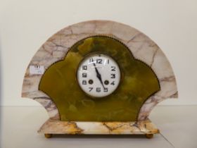 A French Art Deco multi-coloured marble cased clock of fan design; the movement faced by a white
