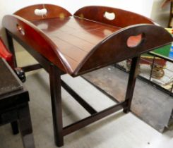 A modern mahogany butler's tray design coffee table, the top with folding flaps, raised on square