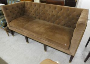 A modern brown fabric button upholstered, box design three person settee, raised on mahogany block