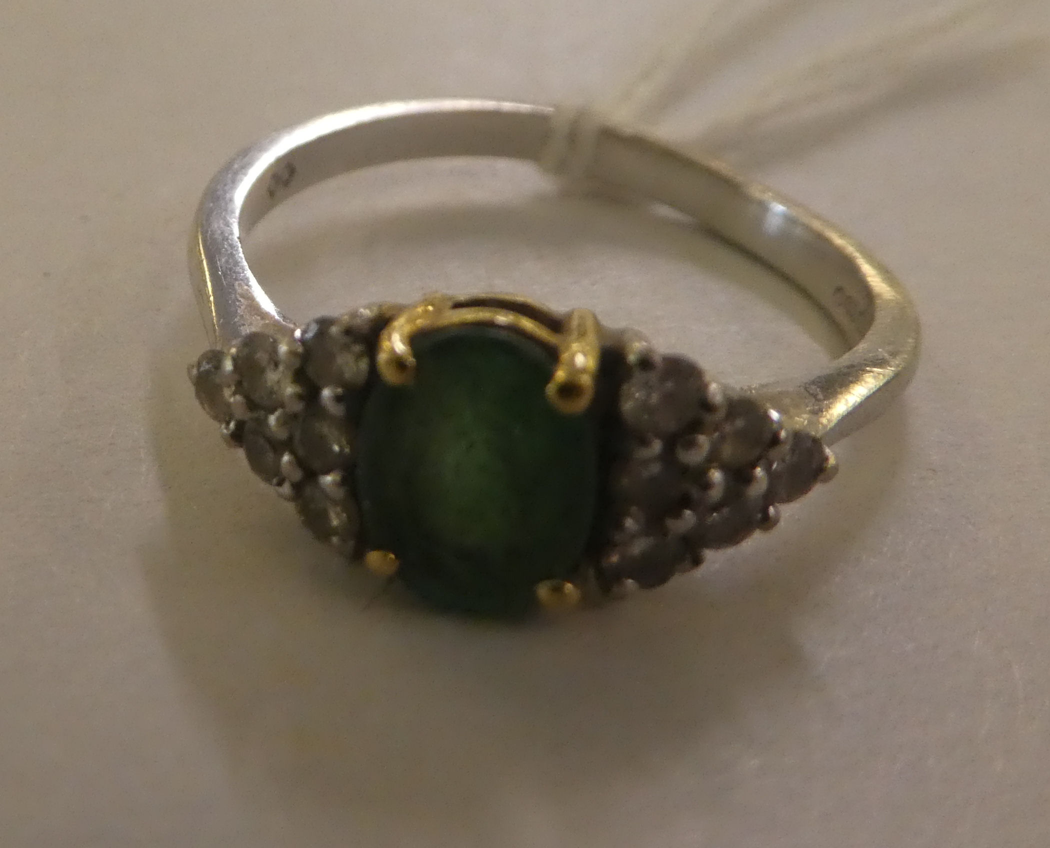 An 18ct gold diamond and emerald ring