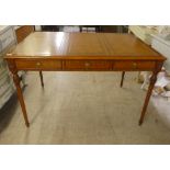 A modern mahogany desk, the top set with a tooled brown hide scriber, over three drawers, raised