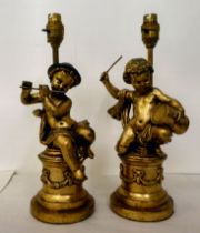 Two 20thC carved giltwood table lamps, fashioned as children playing musical instruments  14"h