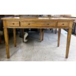 A modern OKA oak desk with three drawers, raised on square, tapered legs  31"h  49"w