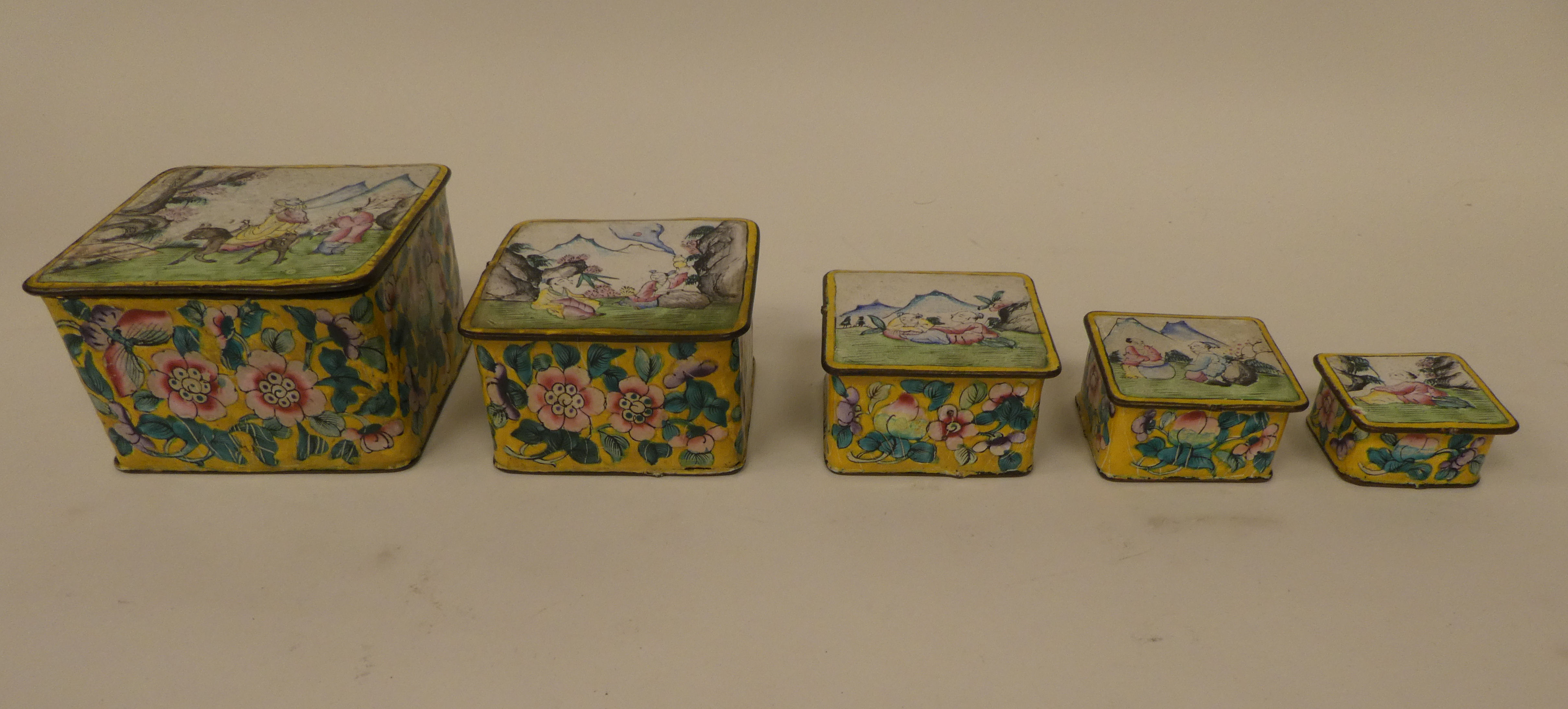 A graduated set of five Chinese coloured enamel boxes, decorated with figures and flora  largest 3.