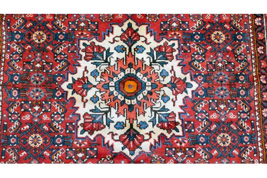 A Persian design rug, decorated with a central medallion, surrounded by geometric designs, on a - Image 2 of 5