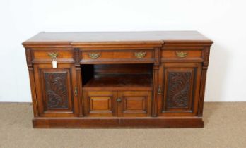 An Edwardian walnut breakfront sideboard