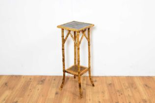 A Victorian bamboo jardiniere/plant stand, with ebonised top panel and gilt floral decoration