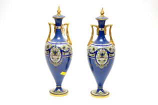 A pair of Royal Worcester twin handled vases and covers