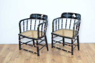 A pair of decoratively painted cane seat chairs