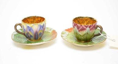 Two floral moulded coffee cups and saucers