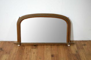 A 20th Century arched overmantel mirror with bronzed frame