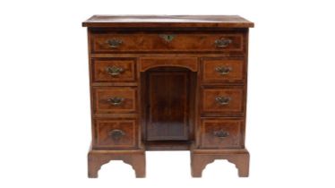 A George II walnut and feather banded kneehole desk