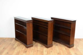A set of three reproduction mahogany three tier open bookcases