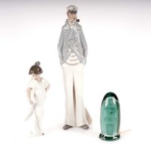 A Lladro figure; a Nao figure; and a paperweight