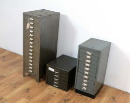 A collection of three retro metal filing cabinets