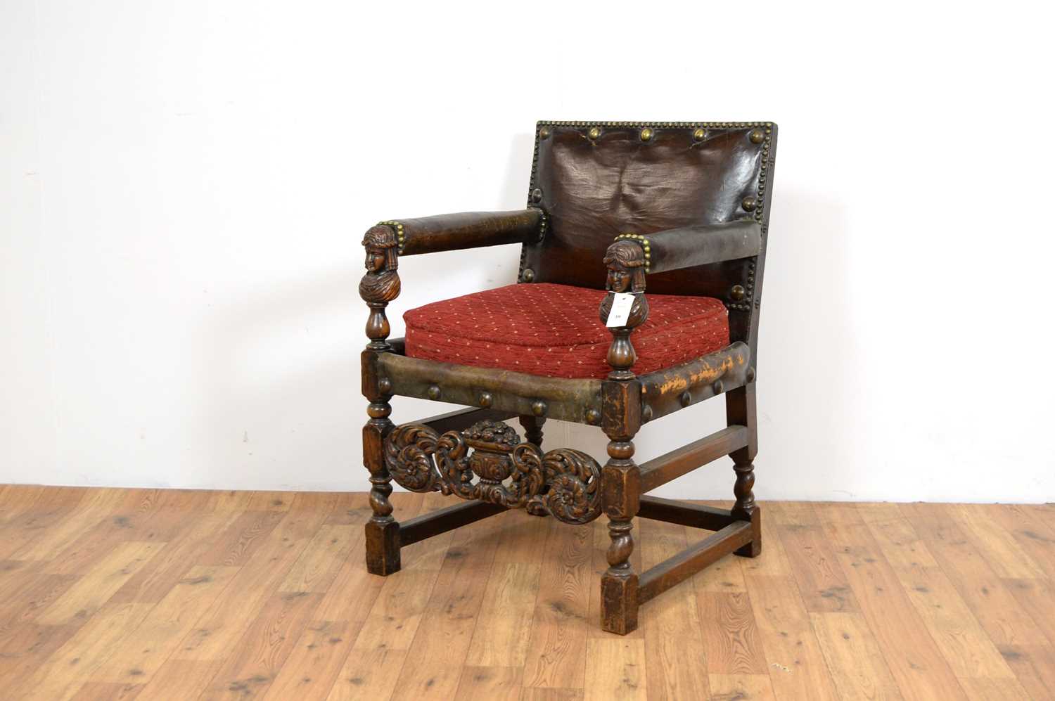 A 20th Century carved oak and leather chair