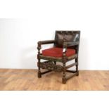 A 20th Century carved oak and leather chair