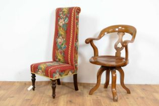A 20th Century swivel action oak Captains chair with a decorative prie dieu chair
