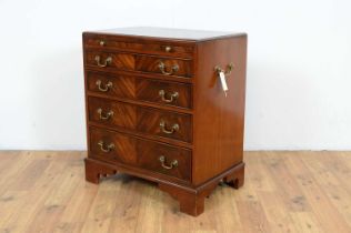 A reproduction mahogany chest of drawers of diminutive size