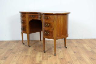 A late 19th Century inlaid mahogany kidney-shaped desk