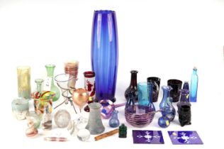 A selection of coloured glass, vase and bottles