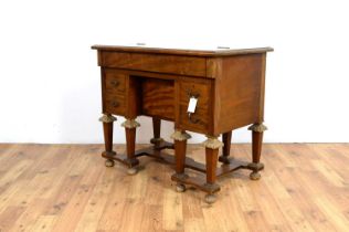 A 20th Century hardwood Mazarin style knee hole desk