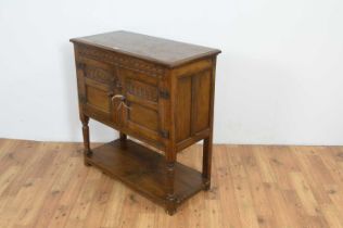 A 1930's Jacobean revival carved oak buffet/hutch