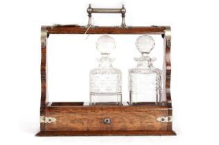 A Victorian oak three bottle tantalus