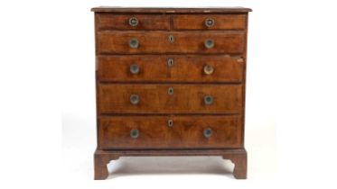 A Georgian cross-banded walnut chest of drawers with later amendments