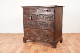 A Georgian oak chest of drawers with later carving