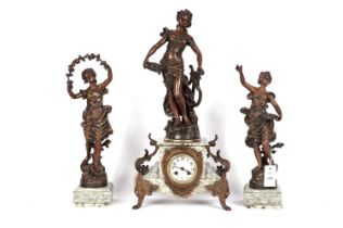 A figural mantle clock, and bronzed figurines
