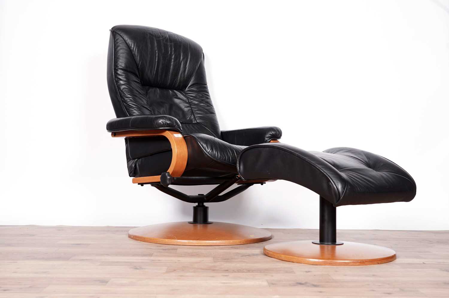 A black leather reclining armchair and stool by ChairWorks - Image 5 of 5