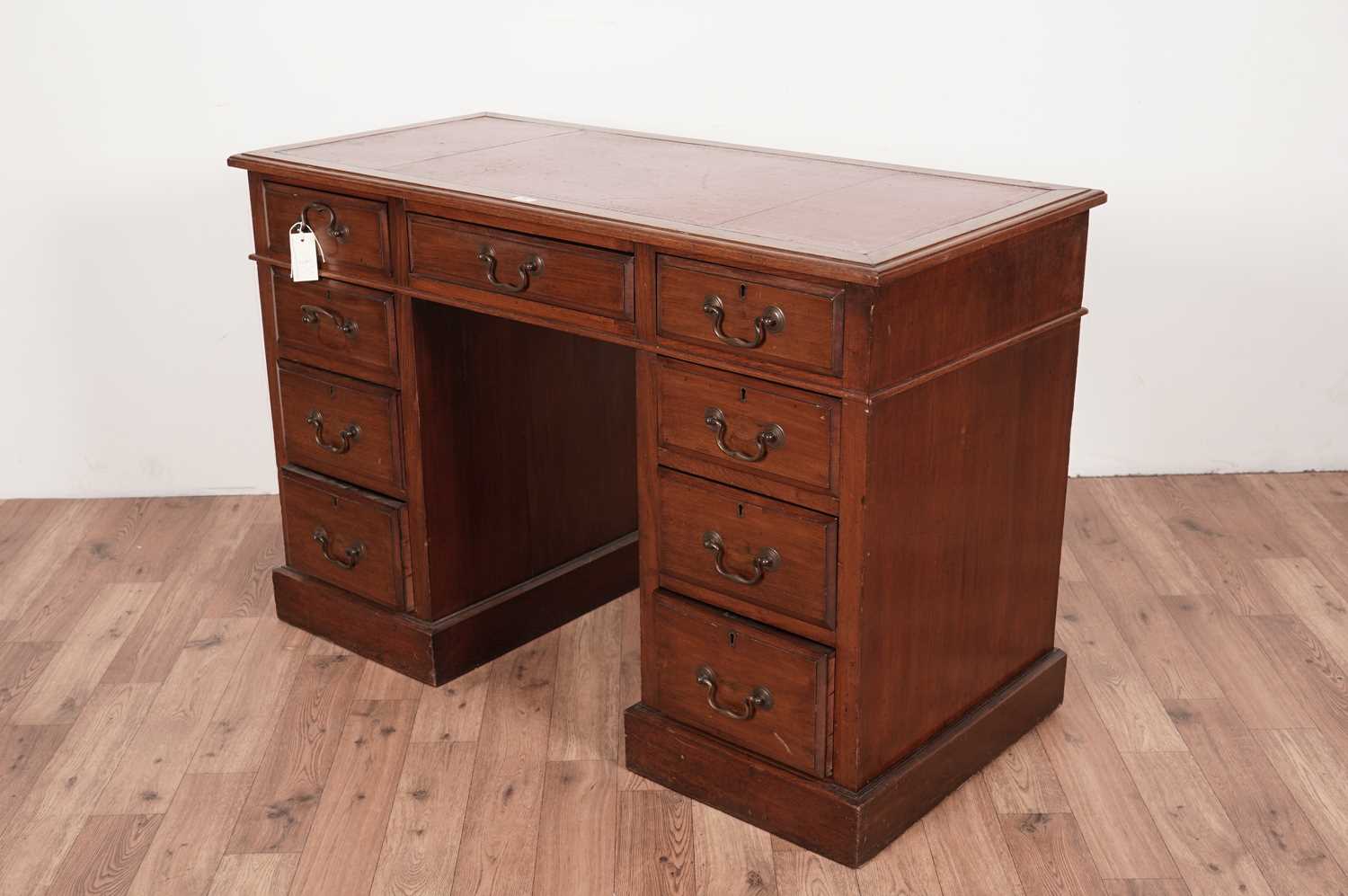 An early 20th Century walnut pedestal desk