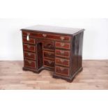 A George III mahogany and satinwood banded kneehole desk