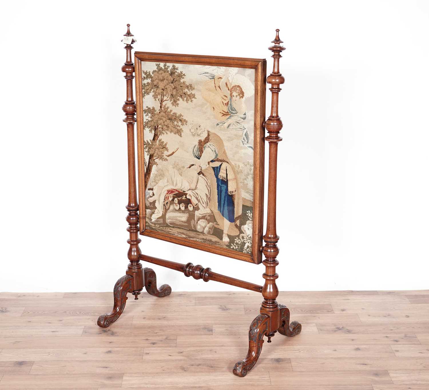 A decorative Victorian carved walnut firescreen