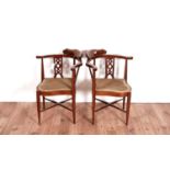 A pair of Edwardian corner armchairs