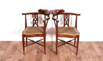 A pair of Edwardian corner armchairs