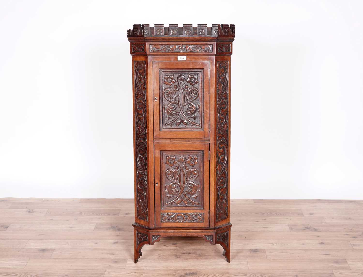 A Victorian carved oak corner cabinet