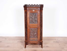 A Victorian carved oak corner cabinet