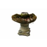 A stone composite bird bath