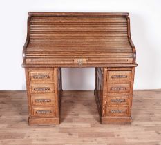 An early 20th Century oak roll-top desk