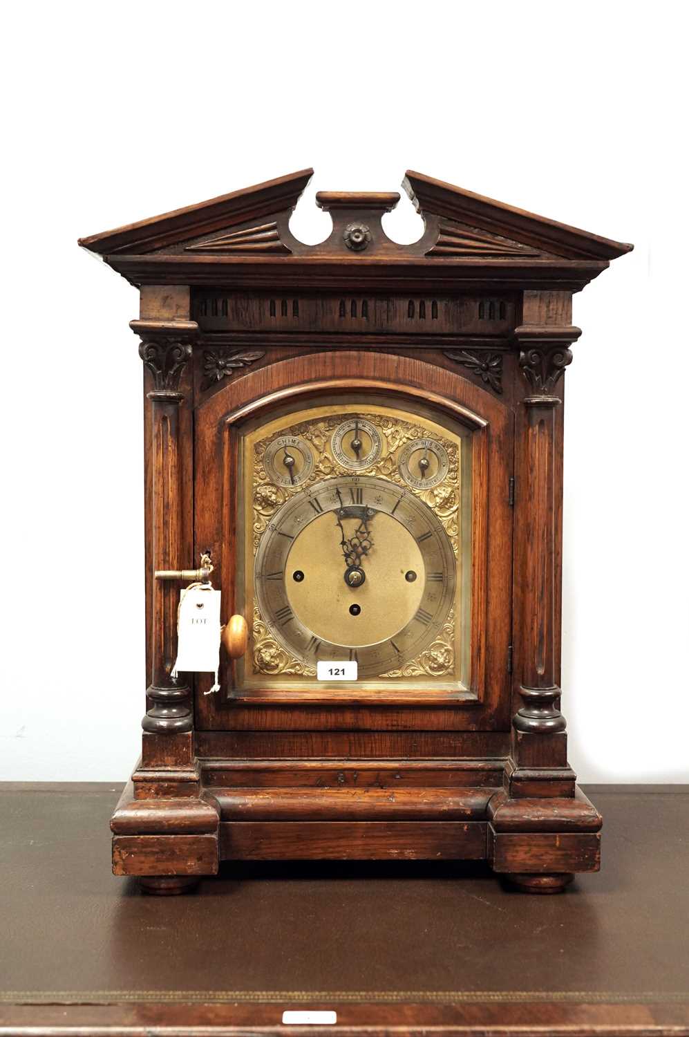 A late 19th Century carved oak bracket clock