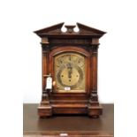 A late 19th Century carved oak bracket clock