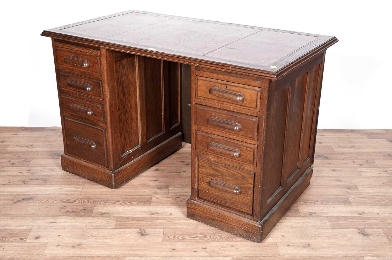 An early 20th Century oak pedestal knee hole desk