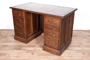 An early 20th Century oak pedestal knee hole desk