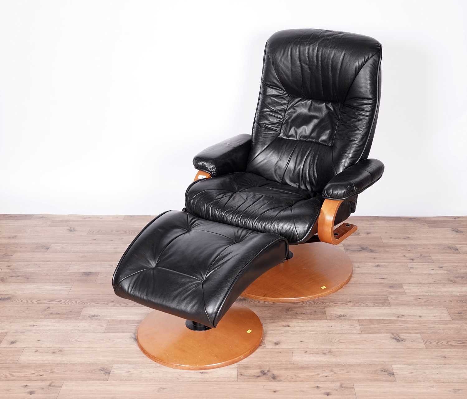 A black leather reclining armchair and stool by ChairWorks - Image 2 of 5