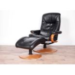 A black leather reclining armchair and stool by ChairWorks