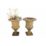 A pair of stone composite garden urns