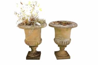 A pair of stone composite garden urns